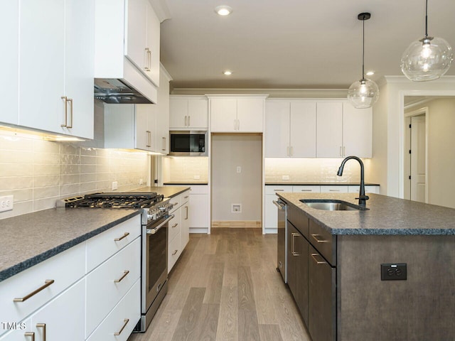 205 Wash Hollow Dr, Wendell, NC 27591 - kitchen featuring sink, white cabinetry, hanging light fixtures, stainless steel appliances, and a center island with sink