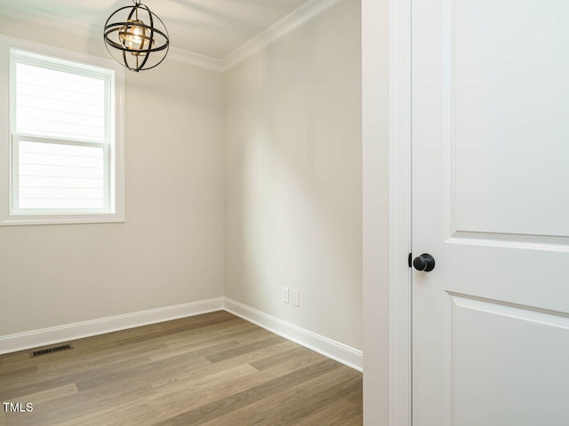205 Wash Hollow Dr, Wendell, NC 27591 - empty room with ornamental molding, an inviting chandelier, and light wood-type flooring