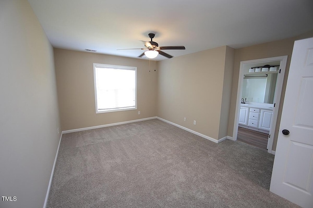 spare room with light carpet and ceiling fan