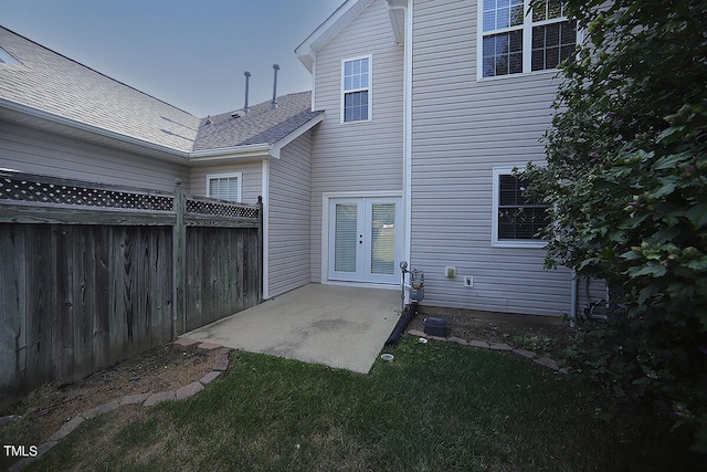 back of property with a yard and a patio area