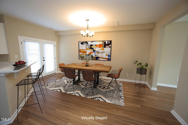 dining space with french doors, an inviting chandelier, and dark wood-type flooring