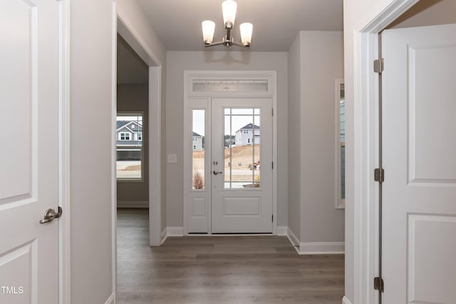 foyer featuring hardwood / wood-style floors and a notable chandelier