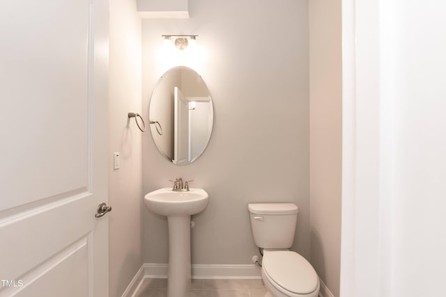 bathroom featuring tile patterned floors and toilet