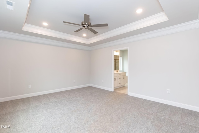 carpeted empty room featuring a tray ceiling, ceiling fan, and ornamental molding