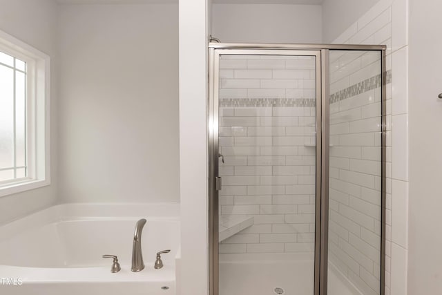 bathroom with shower with separate bathtub