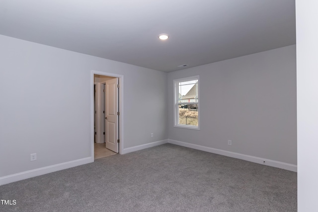 unfurnished room featuring light colored carpet