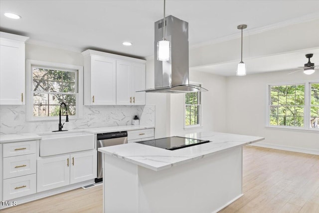 kitchen featuring hanging light fixtures, island exhaust hood, tasteful backsplash, and plenty of natural light