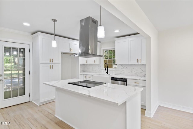 kitchen with hanging light fixtures, backsplash, white cabinets, and extractor fan