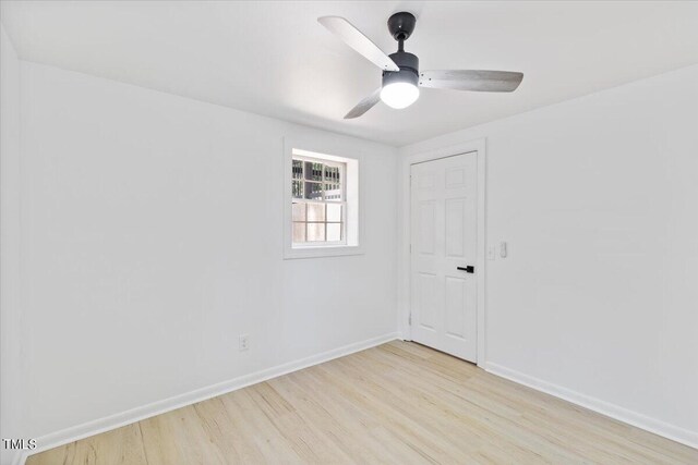 spare room featuring light wood-type flooring and ceiling fan