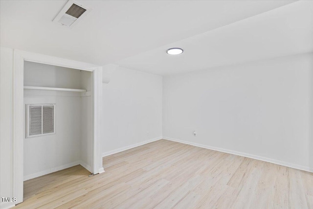 unfurnished bedroom featuring light wood-type flooring and a closet