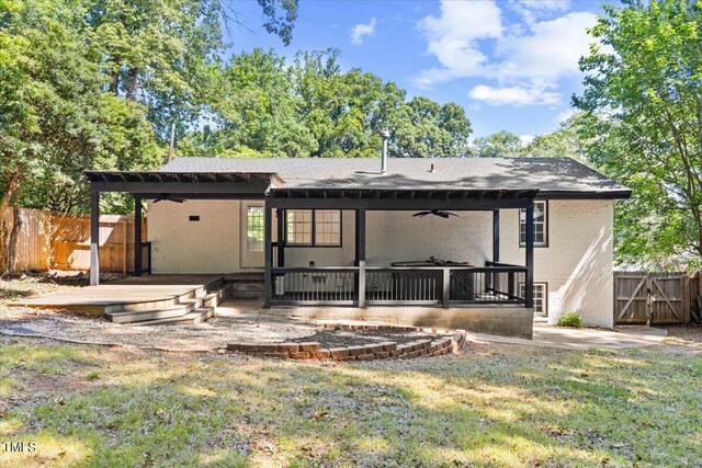 rear view of house with a patio area, a lawn, and ceiling fan