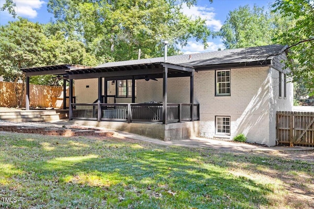 back of house with ceiling fan, a patio, and a lawn