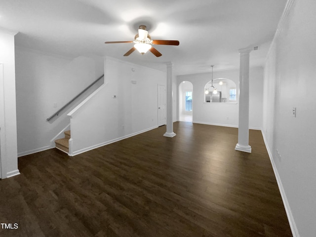 unfurnished living room featuring crown molding, decorative columns, ceiling fan, and dark hardwood / wood-style flooring