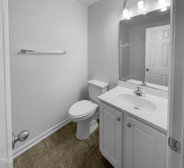 bathroom featuring toilet, tile patterned floors, and vanity