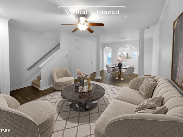 living room with decorative columns, hardwood / wood-style flooring, ceiling fan, and ornamental molding