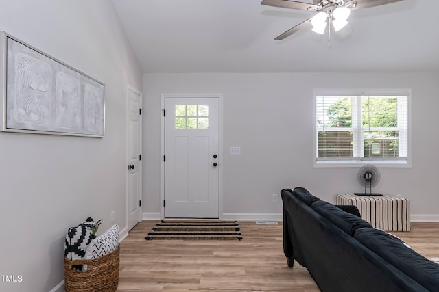 entryway featuring ceiling fan, radiator, lofted ceiling, and light wood-type flooring