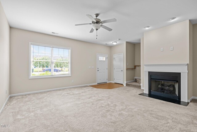 unfurnished living room with carpet flooring and ceiling fan