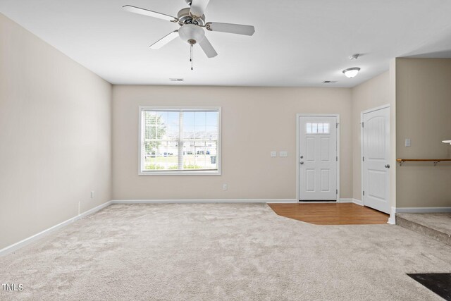 carpeted entryway featuring ceiling fan