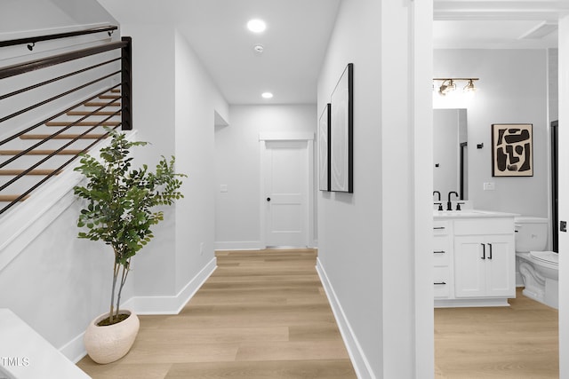 hall featuring sink and light hardwood / wood-style floors