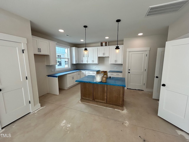 kitchen featuring white cabinetry, a center island, and pendant lighting