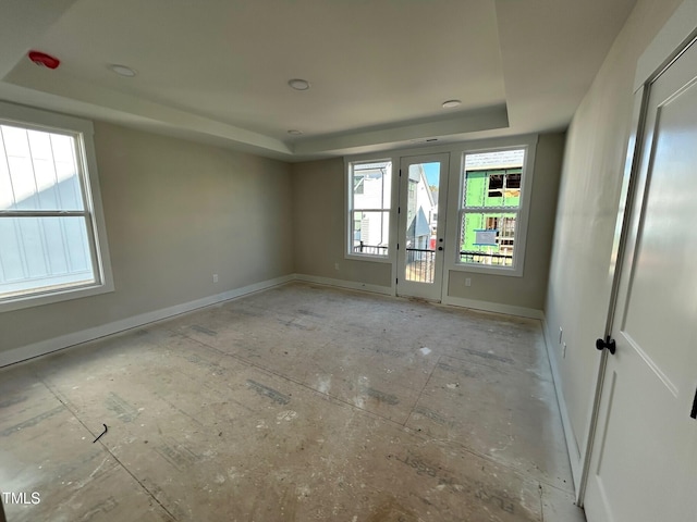 unfurnished room with a raised ceiling