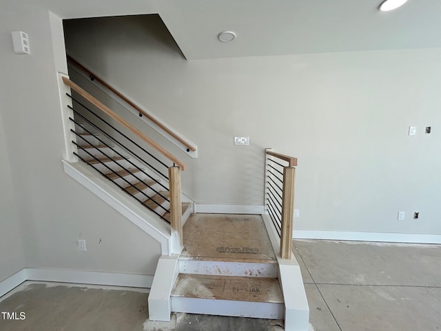 staircase with concrete floors