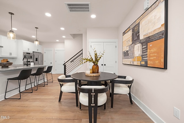 dining room with light wood-type flooring