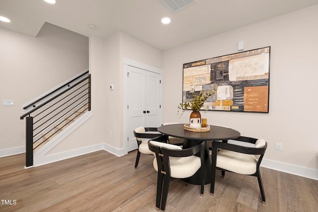 dining space with hardwood / wood-style floors