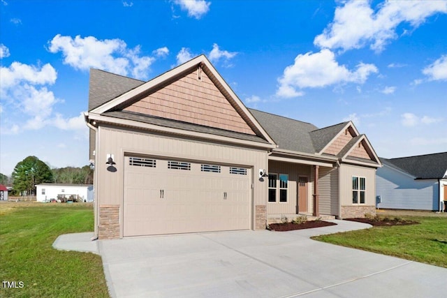 view of front of property featuring a garage, stone siding, a front lawn, and concrete driveway