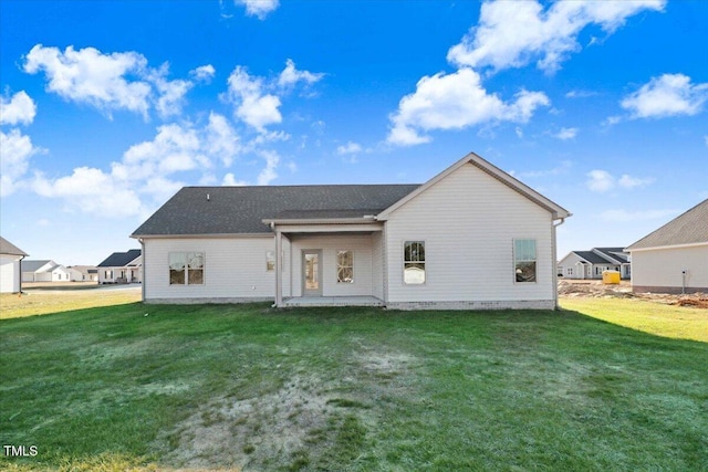 back of house featuring a yard