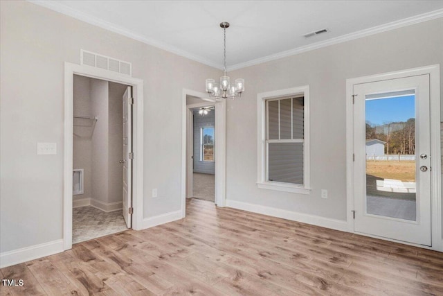 unfurnished dining area with ornamental molding, visible vents, and light wood finished floors