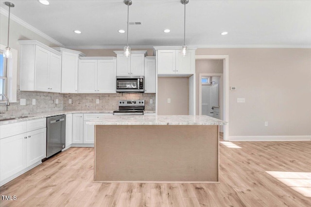 kitchen featuring visible vents, appliances with stainless steel finishes, light wood-style floors, white cabinetry, and a sink