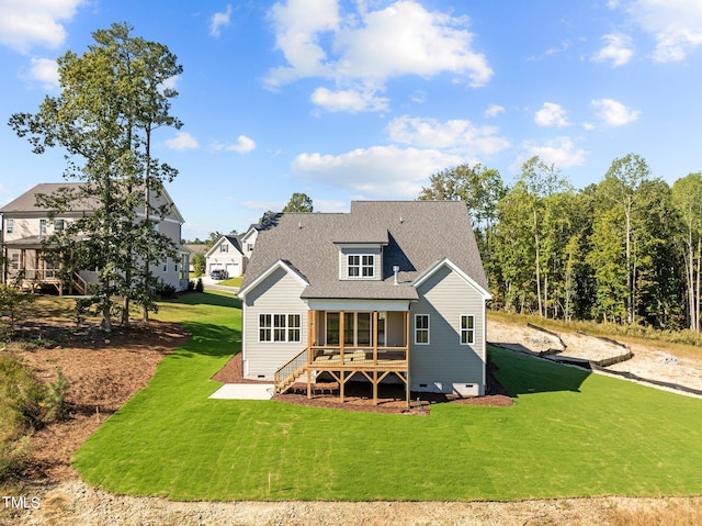 back of property with a lawn and a sunroom