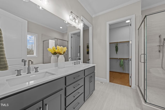 bathroom featuring vanity, crown molding, and a shower with door