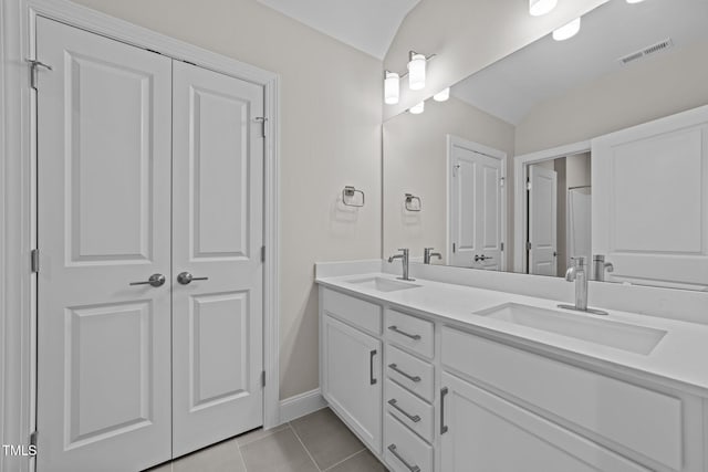 bathroom featuring tile patterned flooring and vanity