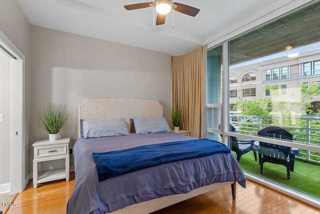 bedroom featuring multiple windows, light hardwood / wood-style flooring, and ceiling fan