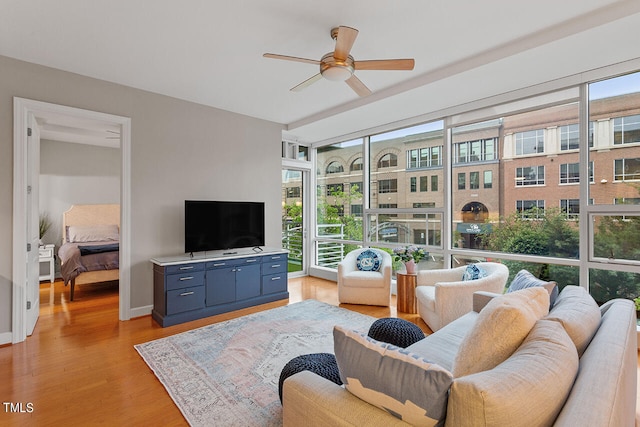 living room with light hardwood / wood-style floors and ceiling fan