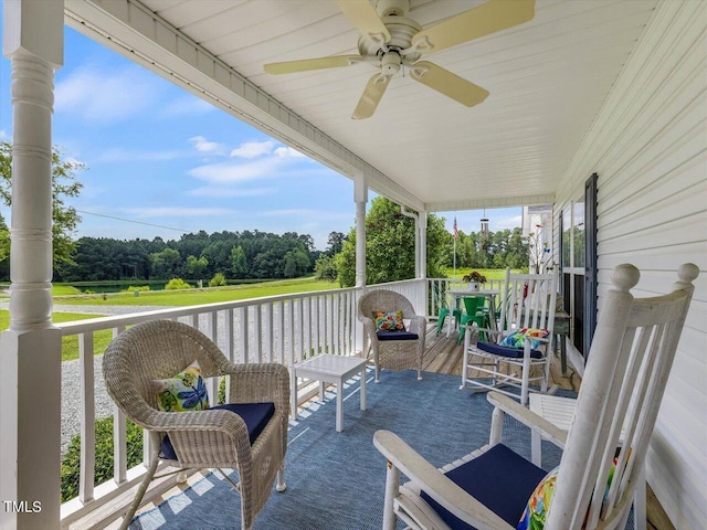 exterior space with a porch and ceiling fan