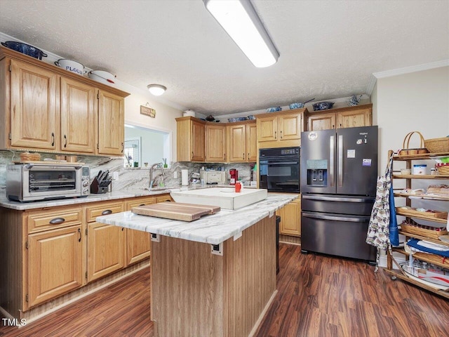 kitchen with a kitchen island, black oven, tasteful backsplash, stainless steel refrigerator with ice dispenser, and a textured ceiling