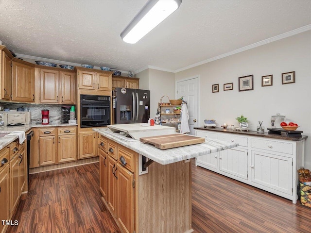 kitchen with backsplash, a center island, black appliances, crown molding, and a textured ceiling