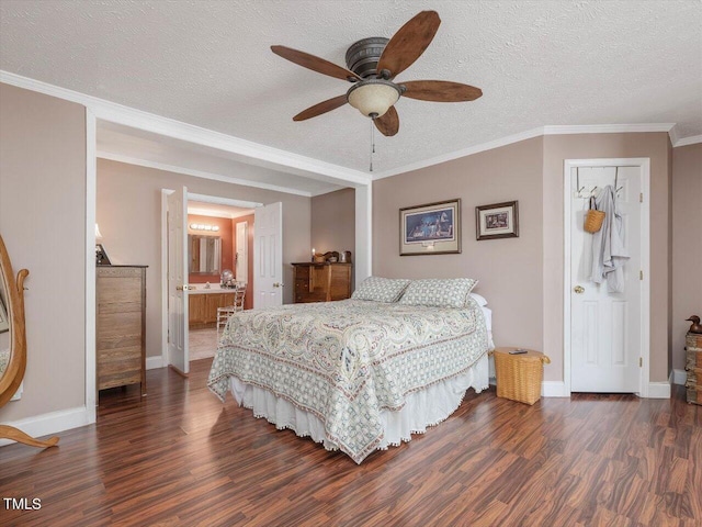 bedroom featuring ceiling fan, ensuite bathroom, dark hardwood / wood-style flooring, and ornamental molding