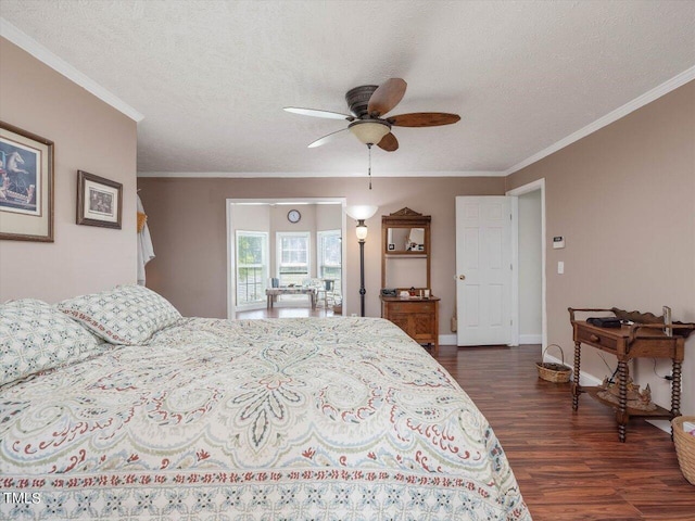 bedroom with a textured ceiling, dark wood-type flooring, ornamental molding, and ceiling fan