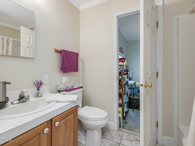 bathroom with vanity, ornamental molding, and toilet