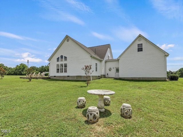 rear view of property featuring a yard