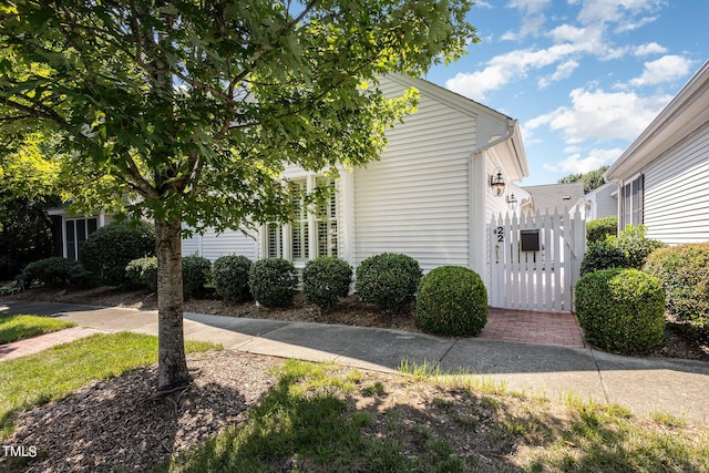 view of side of property with a gate and fence