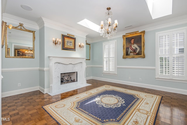 living room with a skylight, a notable chandelier, dark parquet floors, a high end fireplace, and ornamental molding