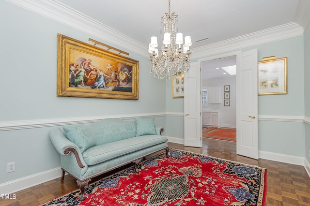 living area featuring ornamental molding, a notable chandelier, and baseboards