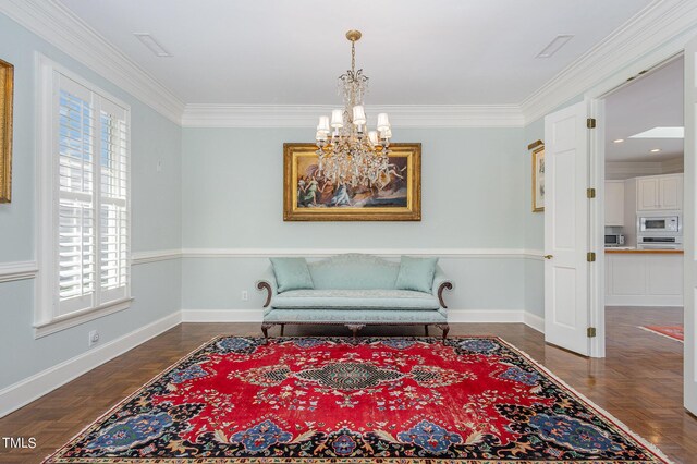 sitting room with a chandelier, a wealth of natural light, and ornamental molding