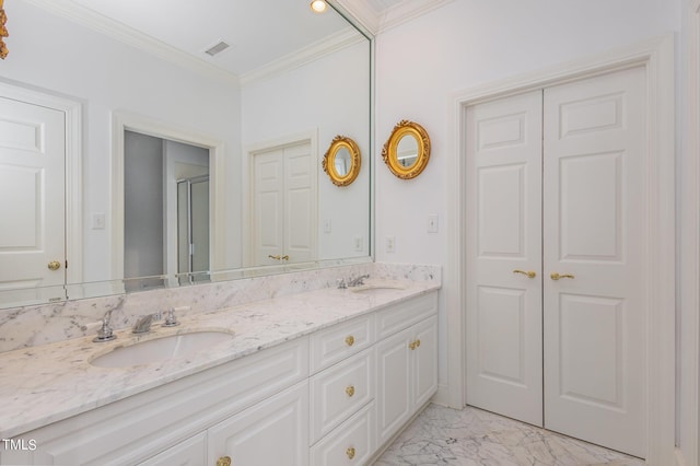 bathroom featuring marble finish floor, double vanity, a closet, ornamental molding, and a sink