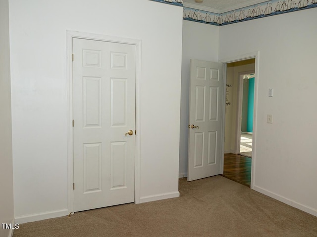 unfurnished bedroom featuring carpet floors and a closet